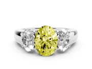 Fancy Yellow Three-Stone Oval Cut Diamond Ring Set in White gold with Matching Prong Settings and Plain Band