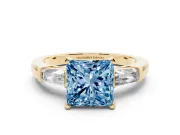 Fancy Blue Princess Cut Diamond Solitaire Ring Set in Yellow gold with Tapered Baguette Side Stones and Prong Setting
