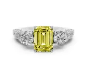 Fancy Yellow Emerald Cut Diamond Three-Stone Ring Set in White gold with Round Side Stones and Pavé Band