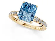 Fancy Blue Radiant Cut Diamond Pavé Solitaire Ring Set in Yellow gold with Round Band and Prong Setting