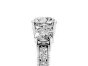 Cushion Cut Diamond Three-Stone Ring Set in Platinum with Round Side Stones and Pavé Band