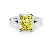 Fancy Yellow Bezel Set Radiant Cut Diamond Solitaire Ring Set in White gold with Tapered Band