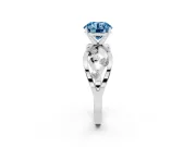 Fancy Blue Round Cut Diamond Solitaire Ring Set in White gold with Side Stones on Criss-Cross Band and Prong Setting
