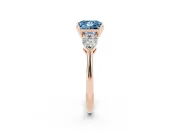 Fancy Blue Three-Stone Princess Cut Diamond Ring Set in Rose gold with Pear Side Stones and Prong Setting