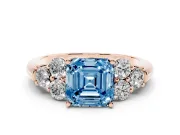 Fancy Blue Asscher Cut Diamond Cluster Ring Set in Rose gold with Round Accent Stones and Prong Setting on a Plain Band