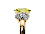 Fancy Yellow Oval Cut Diamond Three-Stone Ring Set in Yellow gold with Bold Center and Classic Band