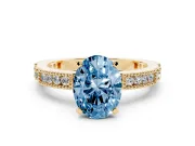 Fancy Blue Oval Cut Diamond Solitaire Ring Set in Yellow gold with Slim Pavé Band and Prong Setting