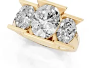 Oval Cut Diamond Three-Stone Channel Set Ring Set in Yellow gold with Smooth Polished Band