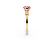 Fancy Pink Three-Stone Round Cut Diamond Ring Set in Yellow gold with Prong Setting and Plain Band