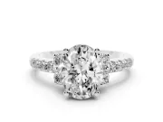 Oval Cut Diamond Three-Stone Pavé Ring Set in Platinum with Prong Setting