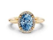 Fancy Blue Oval Cut Diamond Halo Engagement Ring Set in Yellow gold with Plain Split Shank and Prong Setting