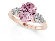 Fancy Pink Three-Stone Oval Cut Diamond Ring Set in Rose gold with Pear Side Stones and Prong Setting