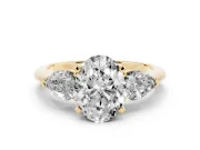 Three-Stone Oval Cut Diamond Ring Set in Yellow gold with Pear Side Stones and Prong Setting