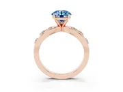 Fancy Blue Round Cut Diamond Solitaire Ring Set in Rose gold with Side Stones on Criss-Cross Band and Prong Setting