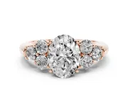 Oval Cut Diamond Cluster Ring Set in Rose gold with Round Accent Stones and Prong Setting on a Plain Band