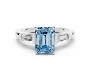 Fancy Blue Emerald Cut Diamond Solitaire Ring Set in White gold with Tapered Baguette Accents and Prong Setting