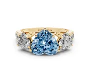 Fancy Blue Heart Cut Diamond Three-Stone Ring Set in Yellow gold with Pavé Band