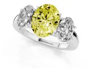 Fancy Yellow Oval Cut Diamond Three-Stone Ring Set in Platinum with Bold Center and Classic Band