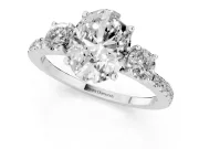 Oval Cut Diamond Three-Stone Ring Set in Silver with Pavé Band and Graduated Sides