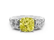 Fancy Yellow Cushion Cut Diamond Three-Stone Ring Set in Platinum with Pavé Band