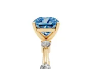 Fancy Blue Cushion Cut Diamond Solitaire Ring Set in Yellow gold with Bezel Set Side Stones and Prong Setting