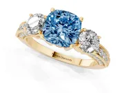 Fancy Blue Cushion Cut Diamond Three-Stone Ring Set in Yellow gold with Round Side Stones and Pavé Band
