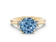 Fancy Blue Three-Stone Round Cut Diamond Ring Set in Yellow gold with Prong Setting and Plain Band