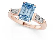 Fancy Blue Emerald Cut Diamond Solitaire Ring Set in Rose gold with Tapered Baguette Side Stones and Prong Setting