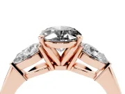 Fancy Black Three-Stone Oval Cut Diamond Ring Set in Rose gold with Pear Side Stones and Prong Setting