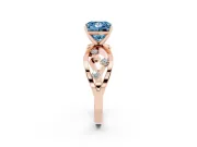 Fancy Blue Princess Cut Diamond Solitaire Ring Set in Rose gold with Side Stones on Criss-Cross Band and Prong Setting