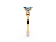Fancy Blue Three-Stone Oval Cut Diamond Ring Set in Yellow gold with Prong Setting and Plain Band