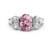 Fancy Pink Oval Cut Diamond Three-Stone Ring Set in Platinum with Polished Band and Prong Setting