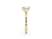 Pear Cut Diamond Solitaire Ring Set in Yellow gold with Bezel Set Side Stones and Prong Setting
