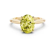 Fancy Yellow Oval Cut Diamond Solitaire Ring Set in Yellow gold with Prong Setting on a Plain Round Band