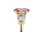 Fancy Pink Three-Stone Oval Cut Diamond Ring Set in Yellow gold with Pear Side Stones and Prong Setting