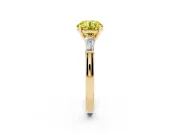 Fancy Yellow Round Cut Diamond Solitaire Ring Set in Yellow gold with Tapered Baguette Side Stones and Prong Setting