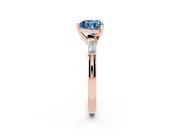 Fancy Blue Heart Cut Diamond Solitaire Ring Set in Rose gold with Tapered Baguette Side Stones and Prong Setting