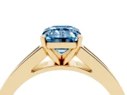 Fancy Blue Emerald Cut Diamond Solitaire Ring Set in Yellow gold with Channel-Set Band and Prong Setting