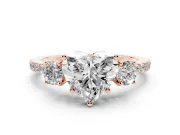 Heart Cut Diamond Three-Stone Ring Set in Rose gold with Pavé Band and Graduated Sides