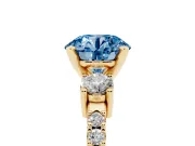 Fancy Blue Three-Stone Round Cut Diamond Pavé Band Ring Set in Yellow gold with Prong Setting