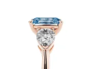 Fancy Blue Three-Stone Emerald Cut Diamond Ring Set in Rose gold with Pear Side Stones and Prong Setting