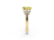 Fancy Yellow Oval Cut Diamond Cluster Ring Set in Yellow gold with Round Accent Stones and Prong Setting on a Plain Band