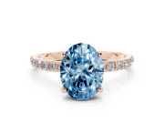 Fancy Blue Oval Cut Diamond Solitaire Ring Set in Rose gold with Round Pavé Band and Prong Setting