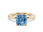 Fancy Blue Cushion Cut Diamond Solitaire Ring Set in Yellow gold with Thin Band and Prong Setting