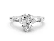 Pear Cut Diamond Solitaire Ring Set in Platinum with Tapered Baguette Accents and Prong Setting