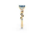 Fancy Blue Emerald Cut Diamond Solitaire Ring Set in Yellow gold with Ribbon Twist Band, Round Accents and Prong Setting