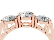 Round Cut Diamond Three-Stone Ring Set in Rose gold with Channel Band and Sturdy Prongs
