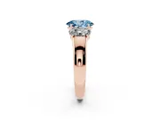 Fancy Blue Three-Stone Oval Cut Diamond Ring Set in Rose gold with Matching Prong Settings and Plain Band