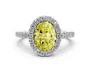 Fancy Yellow Oval Cut Diamond Halo Pavé Solitaire Ring Set in White gold with Prong-Set Center Stone