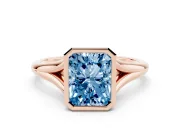 Fancy Blue Bezel Set Radiant Cut Diamond Solitaire Ring Set in Rose gold with Tapered Band